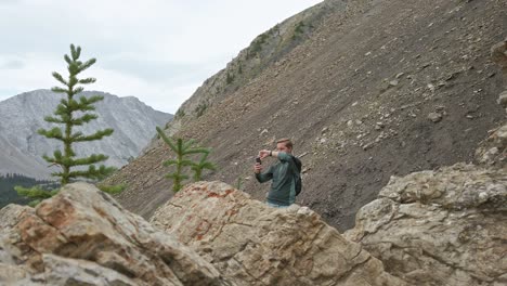 Hiker-taking-photos-in-the-mountains-Rockies-Kananaskis-Alberta-Canada