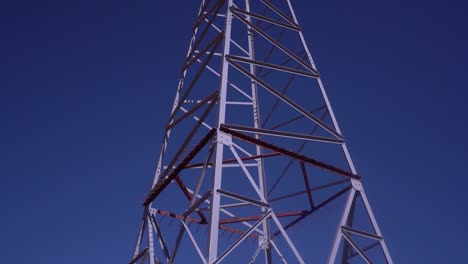 High-Voltage-Electric-Tower-Against-a-Clear-Blue-Sky