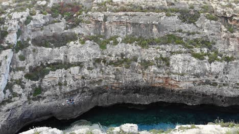 view down to river flyover between rocky cliffs in gozo, ghasri, malta island