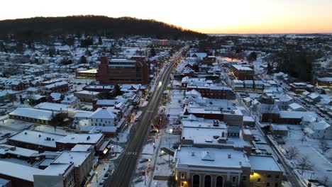high aerial reveals usa town covered in winter snow