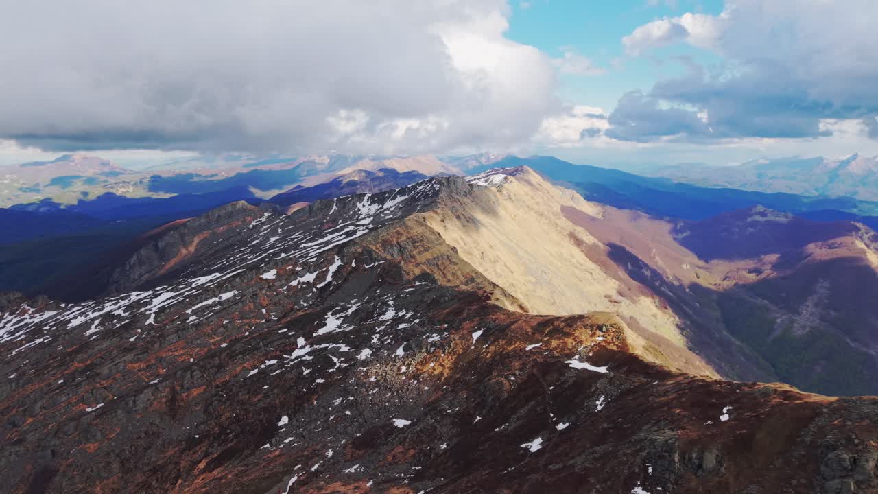 Stunning mountain scenery, vast Dolomites range with snow patches and dramatic clouds
