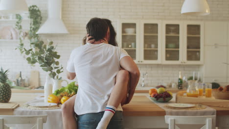 Sensual-couple-kissing-in-the-kitchen