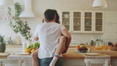 sensual couple kissing in the kitchen