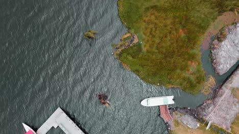 Aerial-Birds-Eye-View-Over-Marina-Pier-At-Lago-San-Pablo-With-Dolly-Forward-Across-Shoreline-In-Otavalo