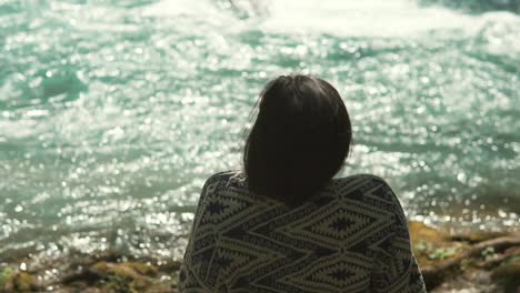 woman relaxing by a river