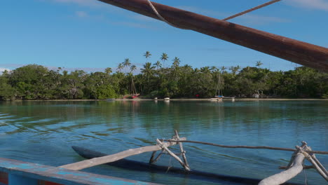 Panning-shot-along-Kanak-pirogue-outrigger-sailing-near-Isle-of-Pines