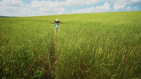 woman running through a wheat field