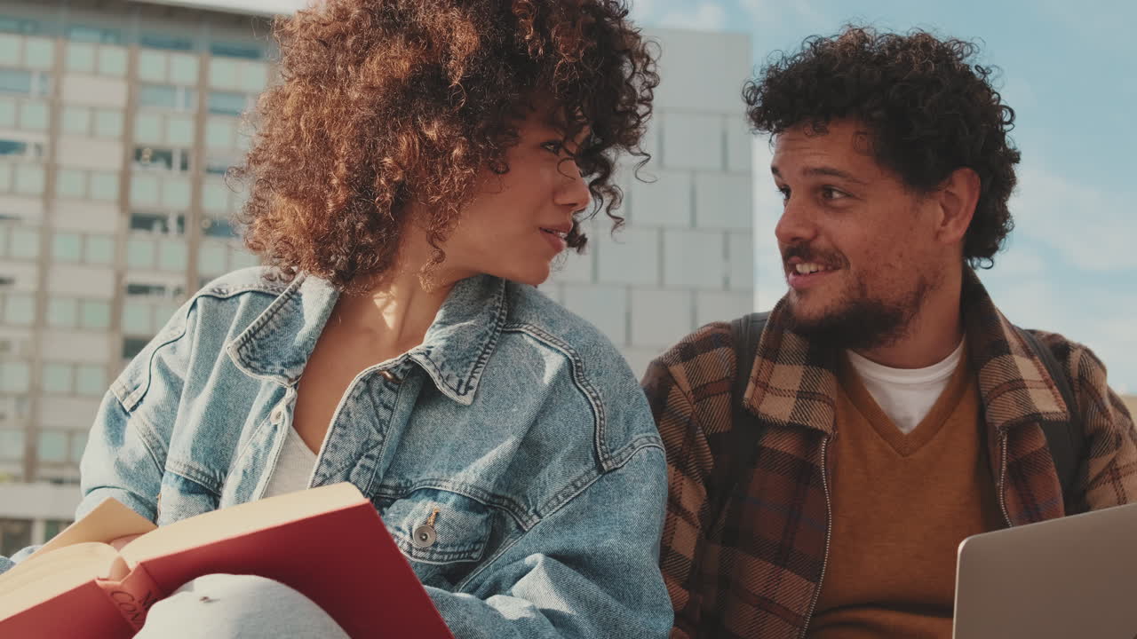 College Students Studying with a Book and Laptop