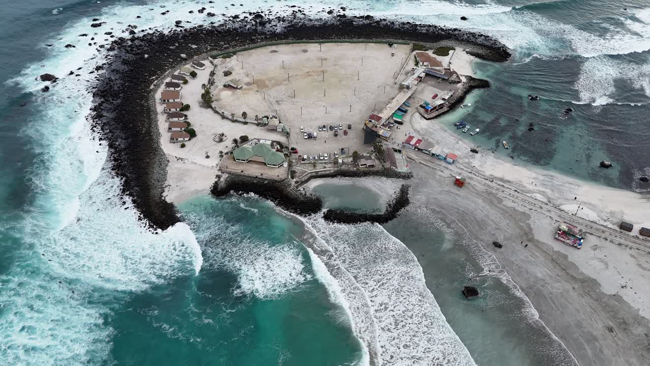 Aerial View of Coastal Peninsula with Resort and Pier