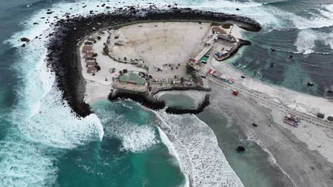 aerial view of coastal peninsula with resort and pier