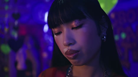 pensive millennial looking smartphone in modern nightclub closeup. girl clubber