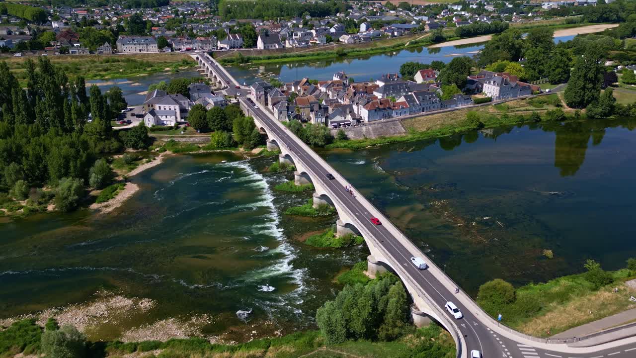 Pont Maréchal Leclerc bridge with traffic crossing Loire river in historic town of Amboise, Loire Valley, France. Aerial drone forward