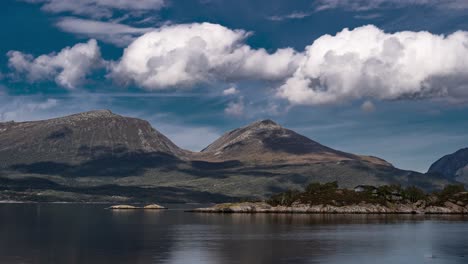 A-timelapse-video-of-the-Norwegian-fjord-landscape-with-the-white-clouds-forming,-whirling,-and-getting-carried-away-by-the-wind