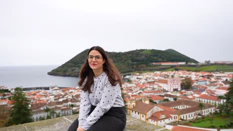 woman smiles, enjoys angra do heroismo view from obelisco do alto da memoria