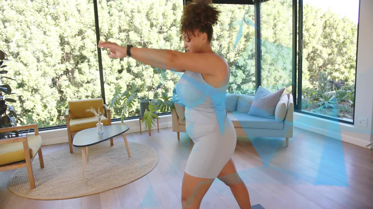 Woman stepping into lunge and moving into backbend for fitness in room, checking wrist device