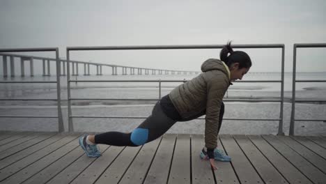 Concentrated-young-brunette-warming-up-before-workout