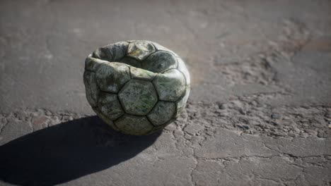 old soccer ball the cement floor