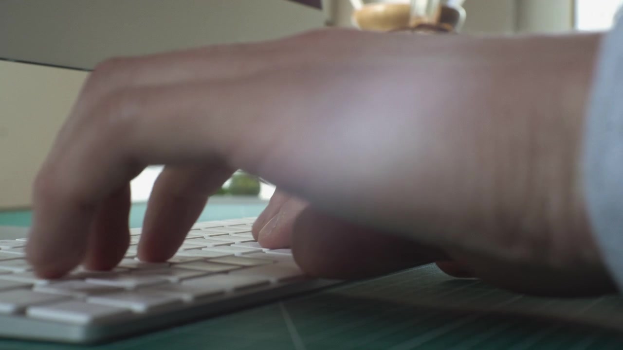 Professional Creative working at His Desk in Home Office Studio typing on keyboard Close Up 4K