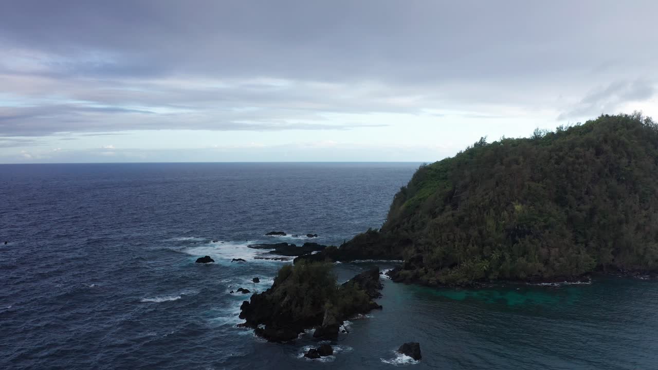 Close-up panning aerial shot of Ka'uiki Head Crater on the edge of Hana Bay in Maui, Hawai'i
