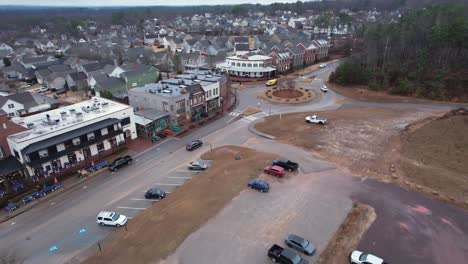 aerial pull away of small town shops and roundabout in front of suburban area at moss rock preserve in hoover, alabama