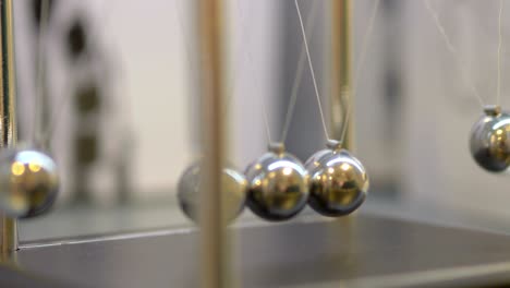 pendulum with swinging metal spheres in 4k slow motion 60fps
