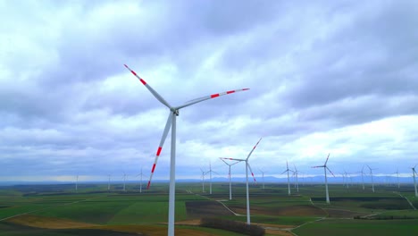 scenic view of wind turbine against clouded horizon in rural farm landscape