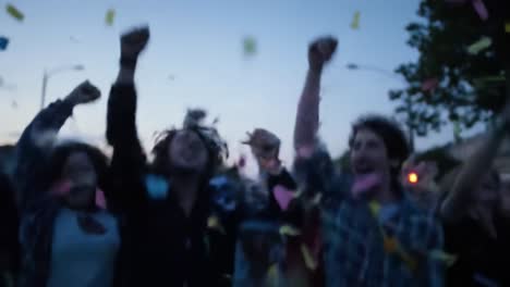 a joyous gathering celebrates with colorful confetti as people eagerly toss their joy into the evening sky, creating a vibrant atmosphere of excitement and unity