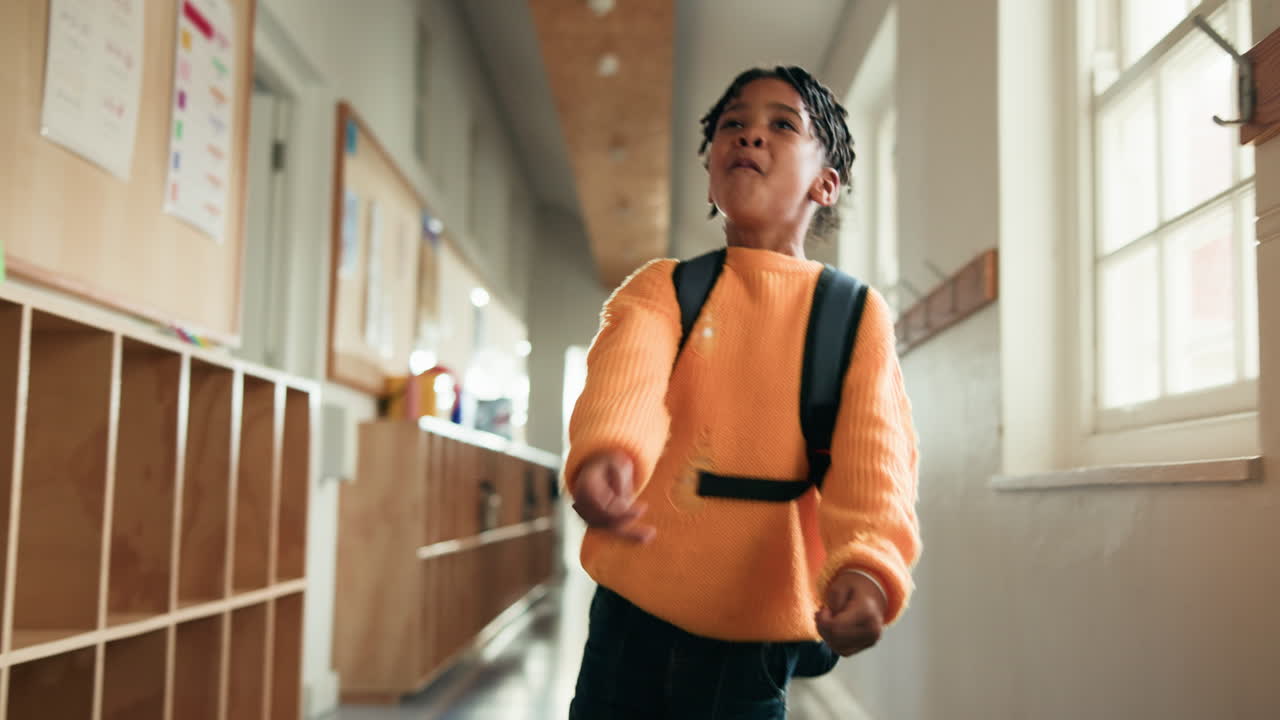 Boy Running Down School Hallway