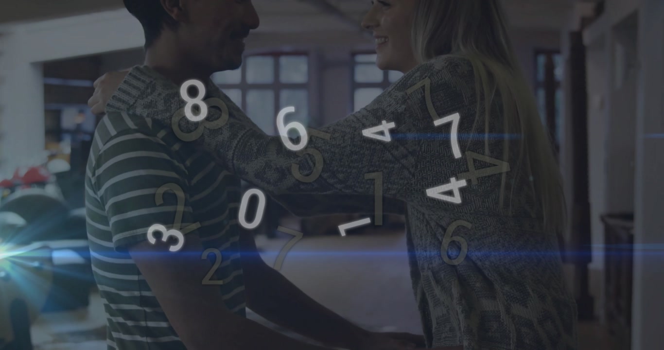 man entering studio and kneeling while lifting woman into embrace with swirling tech numbers