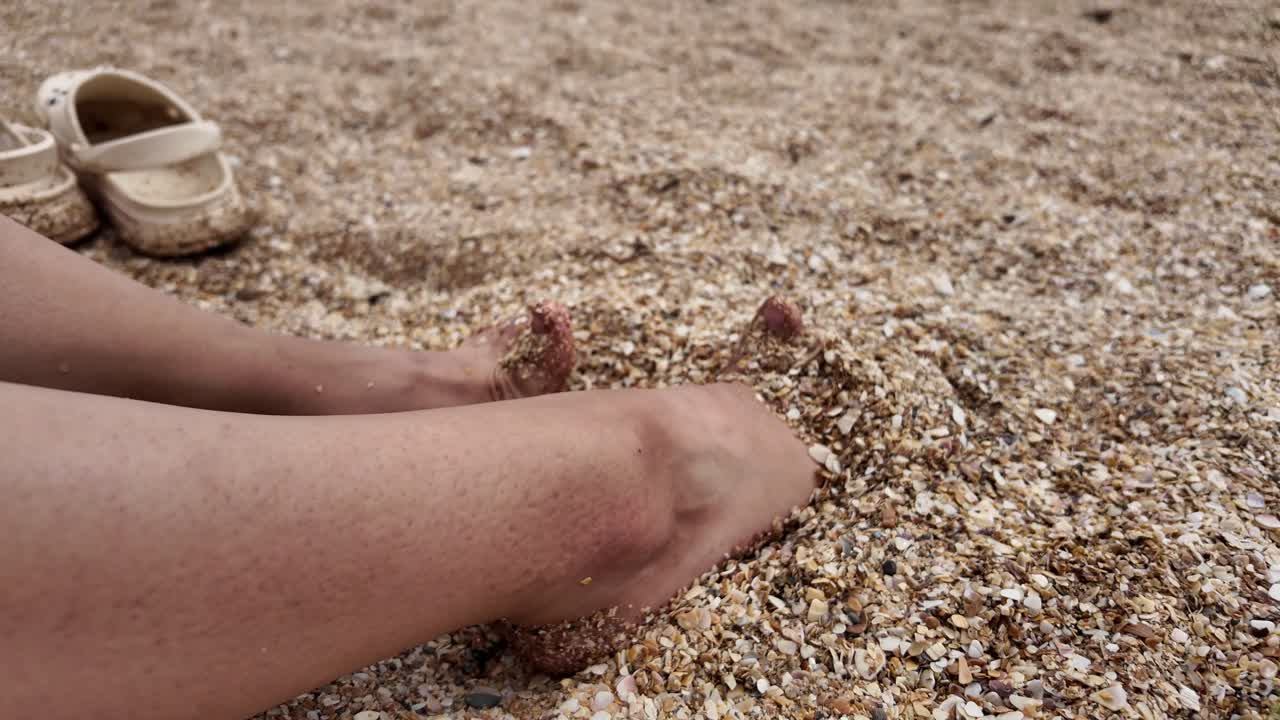 Woman's Feet in the Sand on a Beach