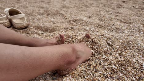 woman's feet in the sand on a beach