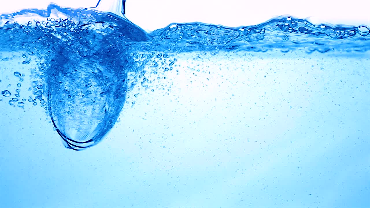Water with a mixer whisk, slow-motion shooting.