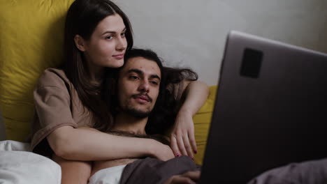 couple in bed kissing each other