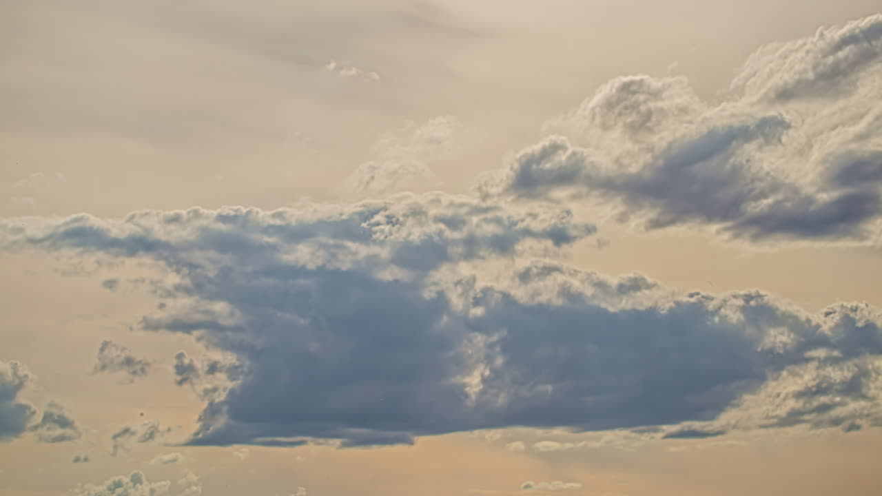 Dramatic sky timelapse of clouds blue moving in the yellow sunset
