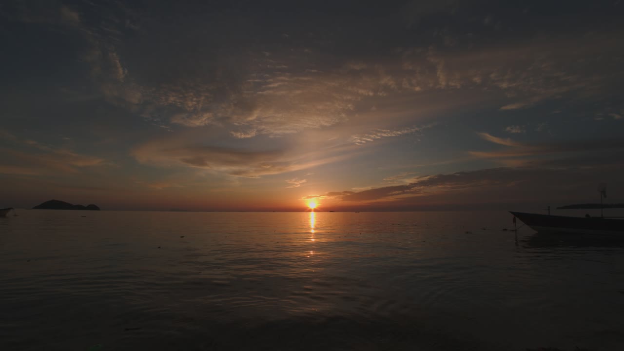 Sun goes down to the sea with light reflection on water