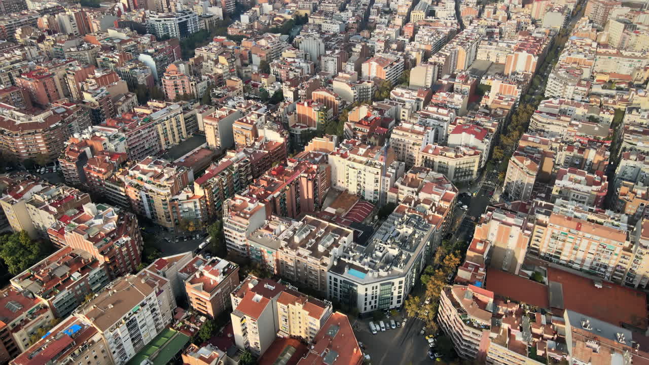 Aerial drone view of Barcelona, Spain. Blocks with multiple residential buildings, roads with cars