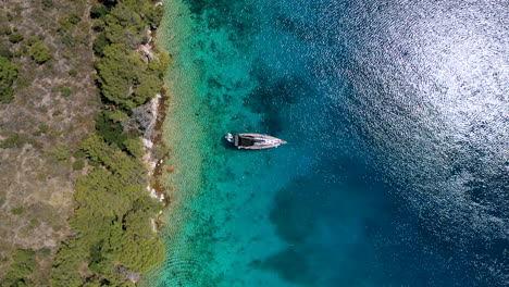 boats floating on sparkling blue water of sea in lastovo island, croatia. - aerial drone, top view