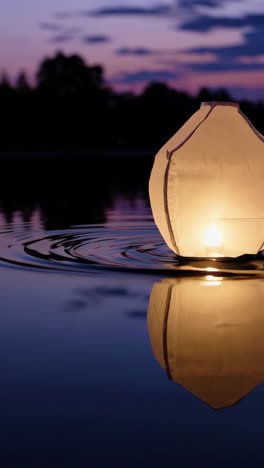 floating sky lantern at sunset
