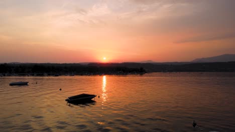 idyllic sunset above lago di garda and soto city, lombardy, italy