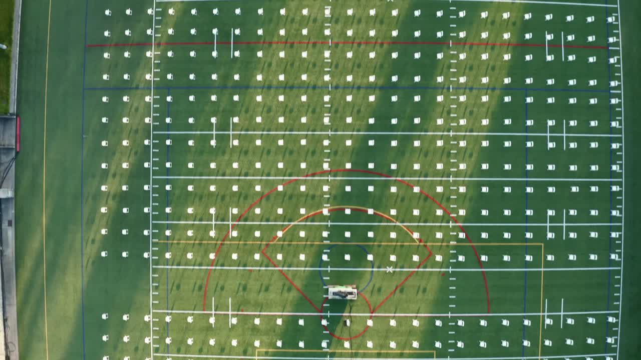 Aerial Vertical View Of Campus Field With Rows Of White Chairs Neatly Arranged For Graduation Event At The University Of Puget Sound In Tacoma, Washington, USA - Drone Shot