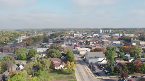 Aerial-drone-shot-panning-across-a-small-rural-farm-town-in-the-Midwest,-US