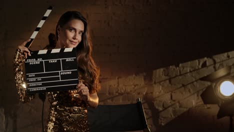 Woman Holding Clapperboard on Film Set