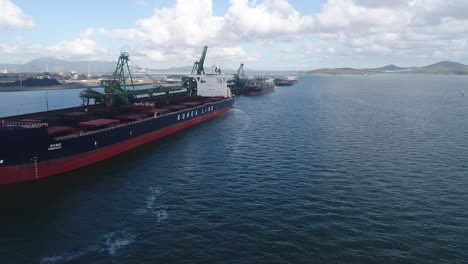 drone shot of large coal ships docked in port, gladstone queensland australia