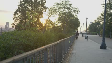 Black-Male-in-Fancy-Street-Clothes-Walking-Towards-Screen-Along-Empty-Path-In-Barcelona,-Spain-at-Sunrise-in-6K