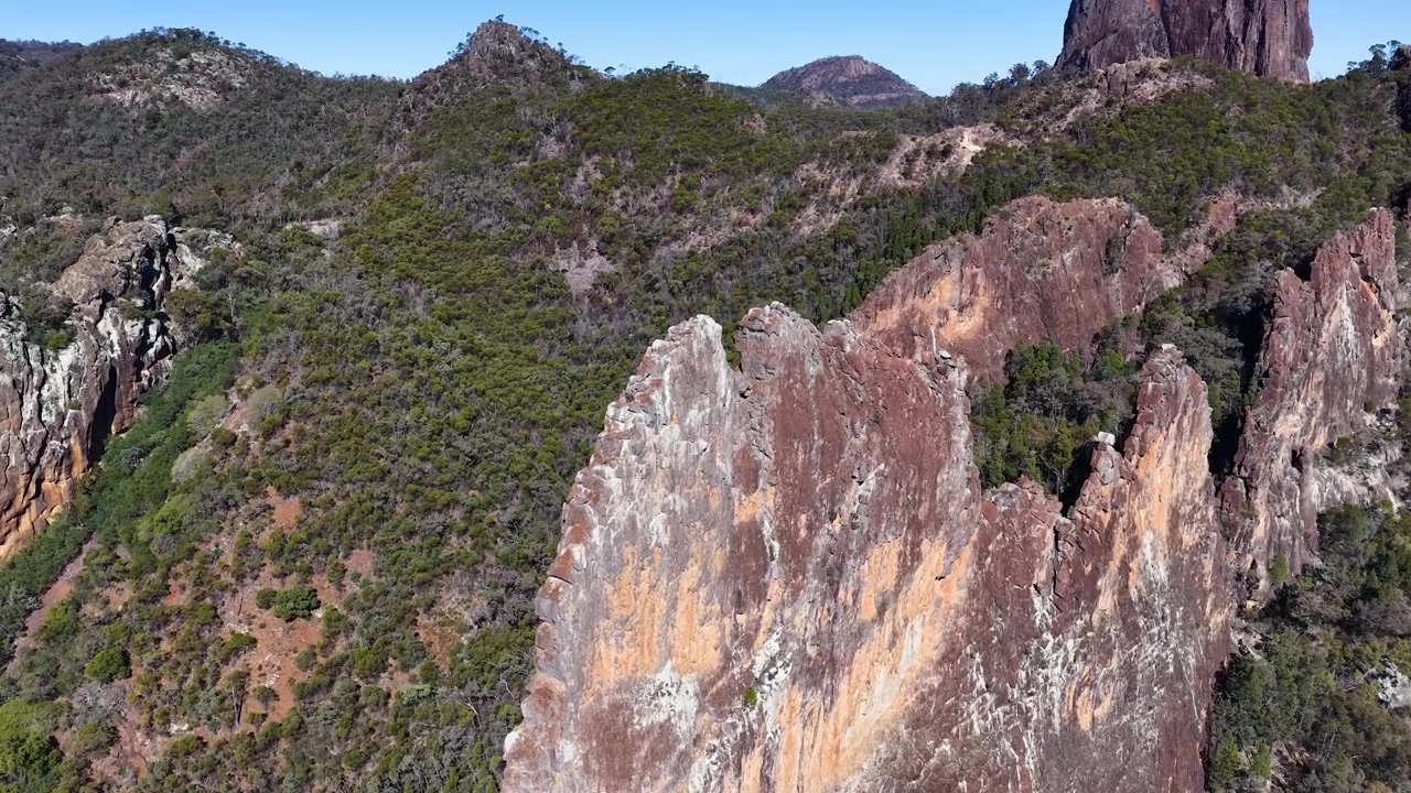 Ripresa con drone di guglie di roccia vulcanica e terreno montuoso aspro nel Parco Nazionale Warrumbungle, Australia