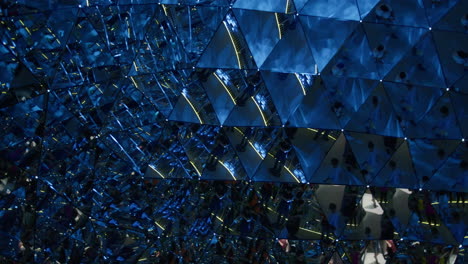 hall of mirrors installation with people walking through