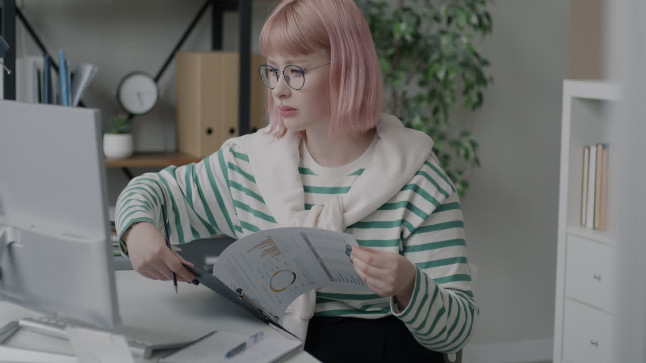 Woman working on paperwork in office setting