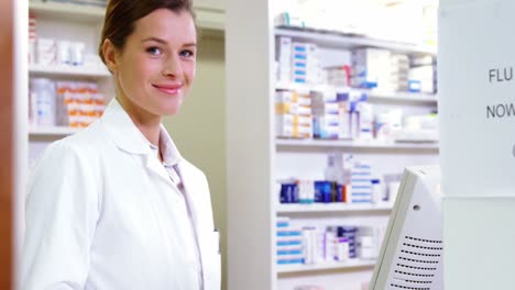 smiling pharmacist holding barcode scanner