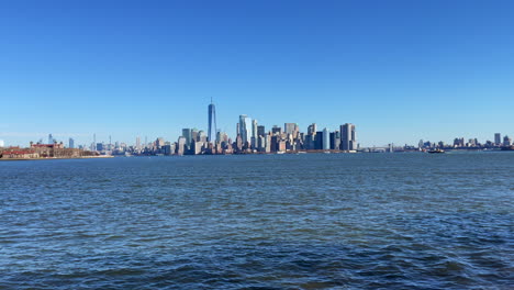 calm rippling water at the skyline of new york city on a clear day