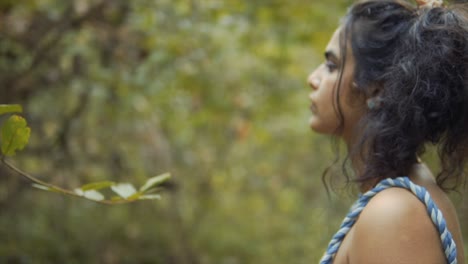 Close-up-Young-tan-skinned-Indian-girl-with-cold-expression-in-the-garden